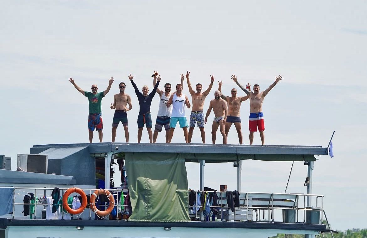 The WaveBorn crew celebrating on the rooftop deck of the Ombak Kabau