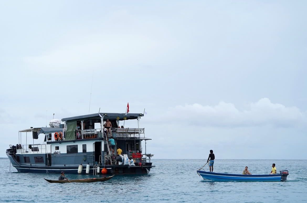 The Ombak Kabau loading up with a tender boat alongside